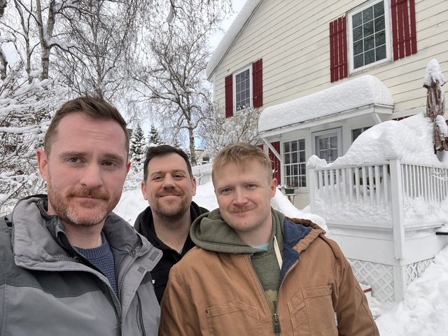 Sean, Dave, and Taylor in the snow outside a house